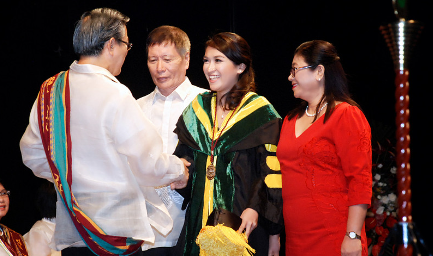 Graduate receiving diploma during ceremony